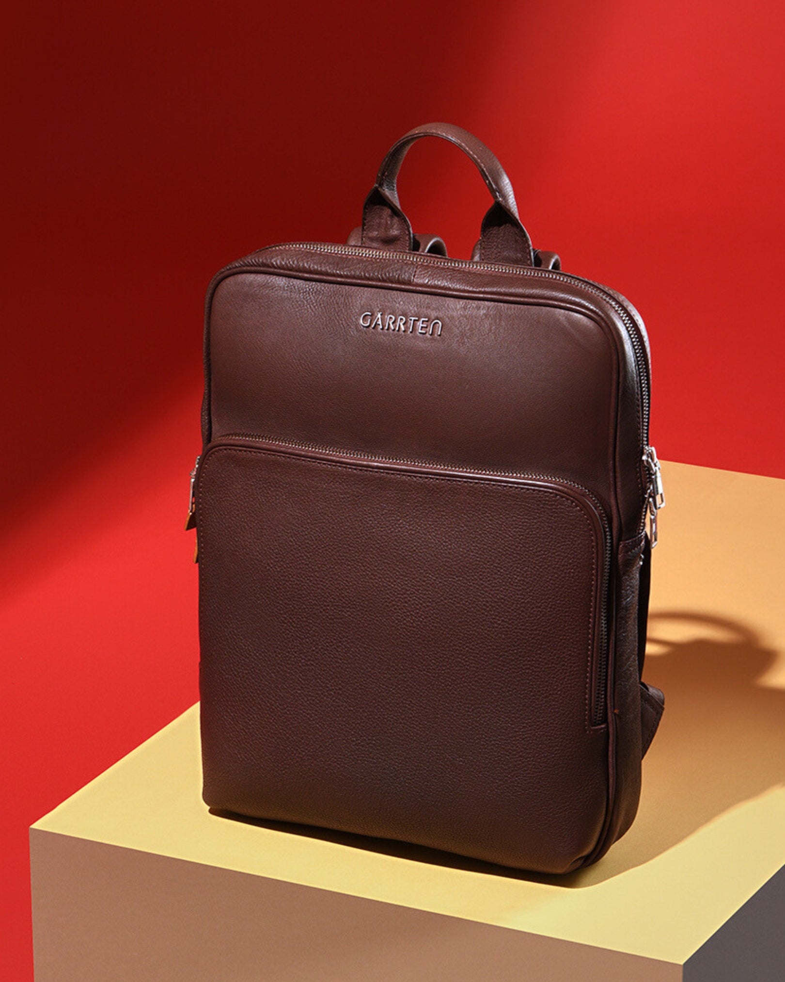 Vintage Mahogany Brown: tilted front view of Garrten slim full grain leather backpack
