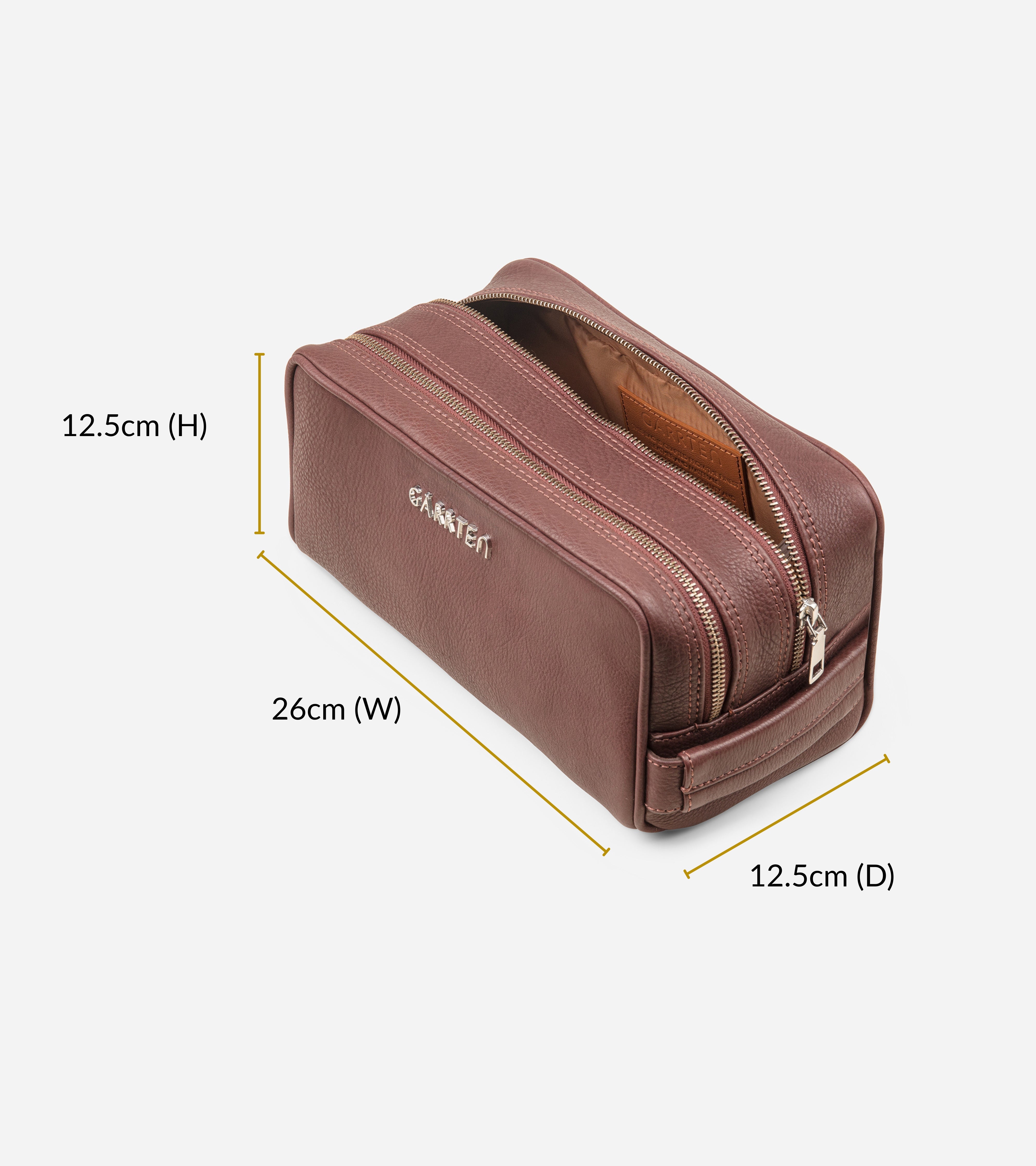 Dopp kit or toiletry bag style in vintage mahogany brown leather with measurements on a white background