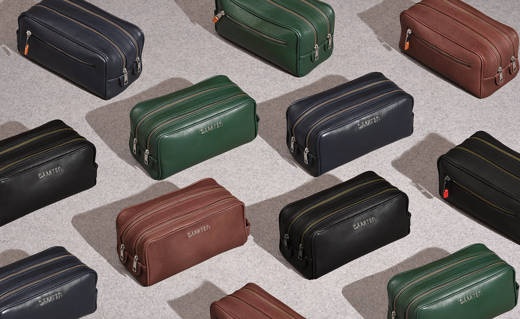 garrten collection shot of leather dopp kits on grey background