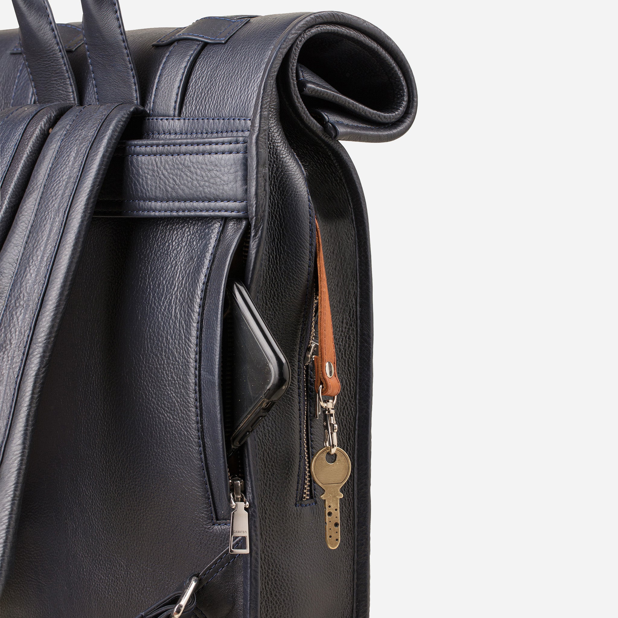Midnight Blue: back view showing quick access pocket and keychain strap of Garrten's rolltop style full grain leather backpack