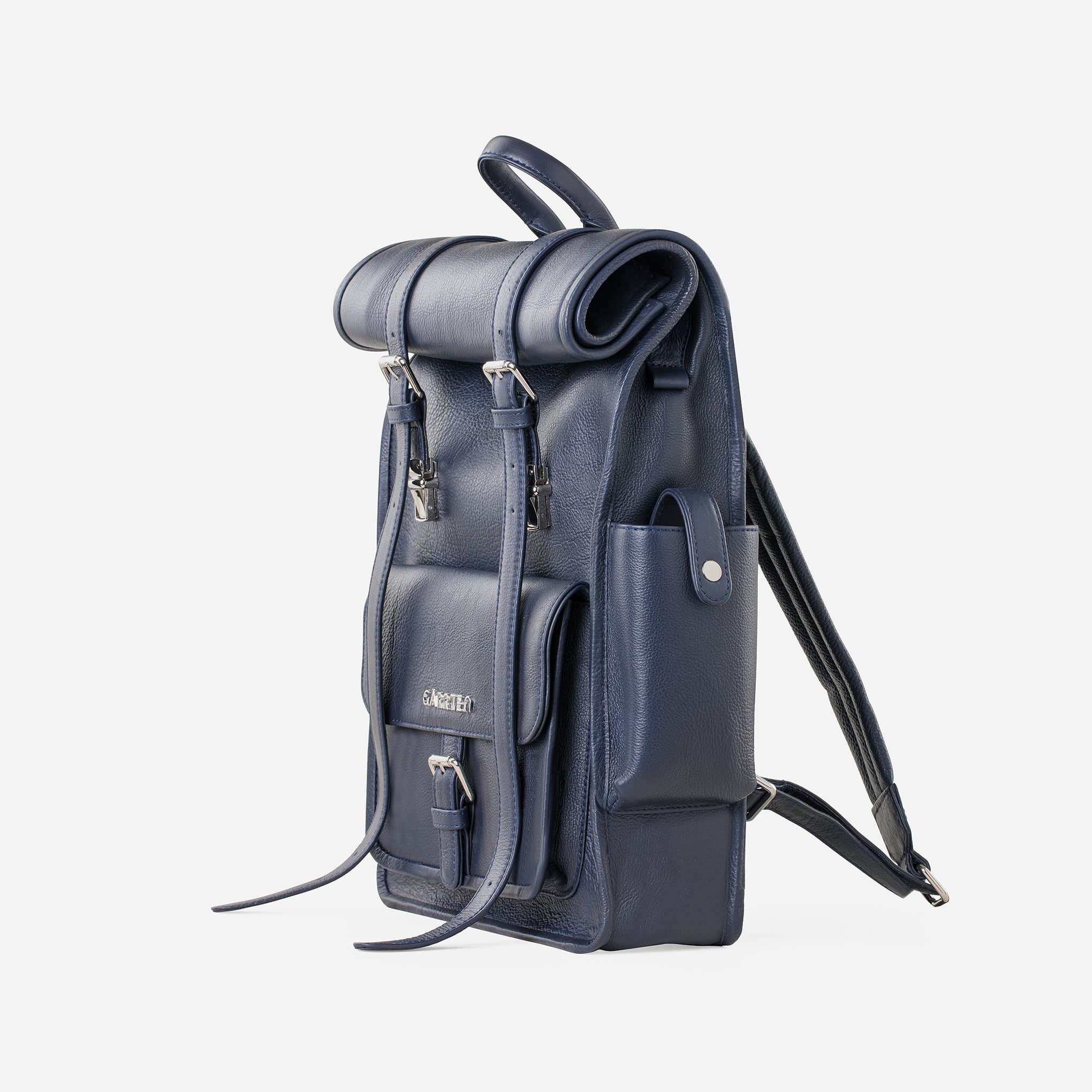 Blue: right side view showing outer pocket of Garrten rolltop style full grain leather backpack