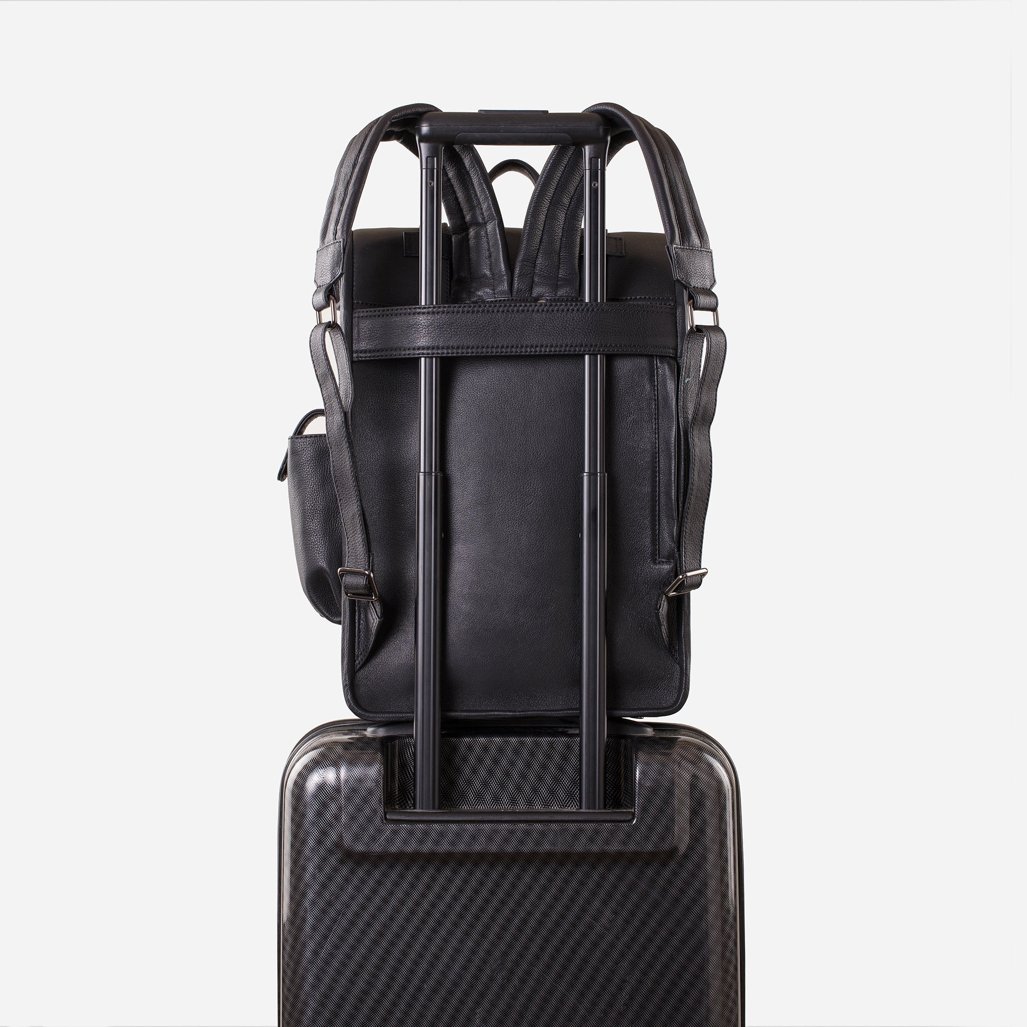Carbon Black: back view showing trolley sleeve usage of Garrten rolltop style full grain leather backpack