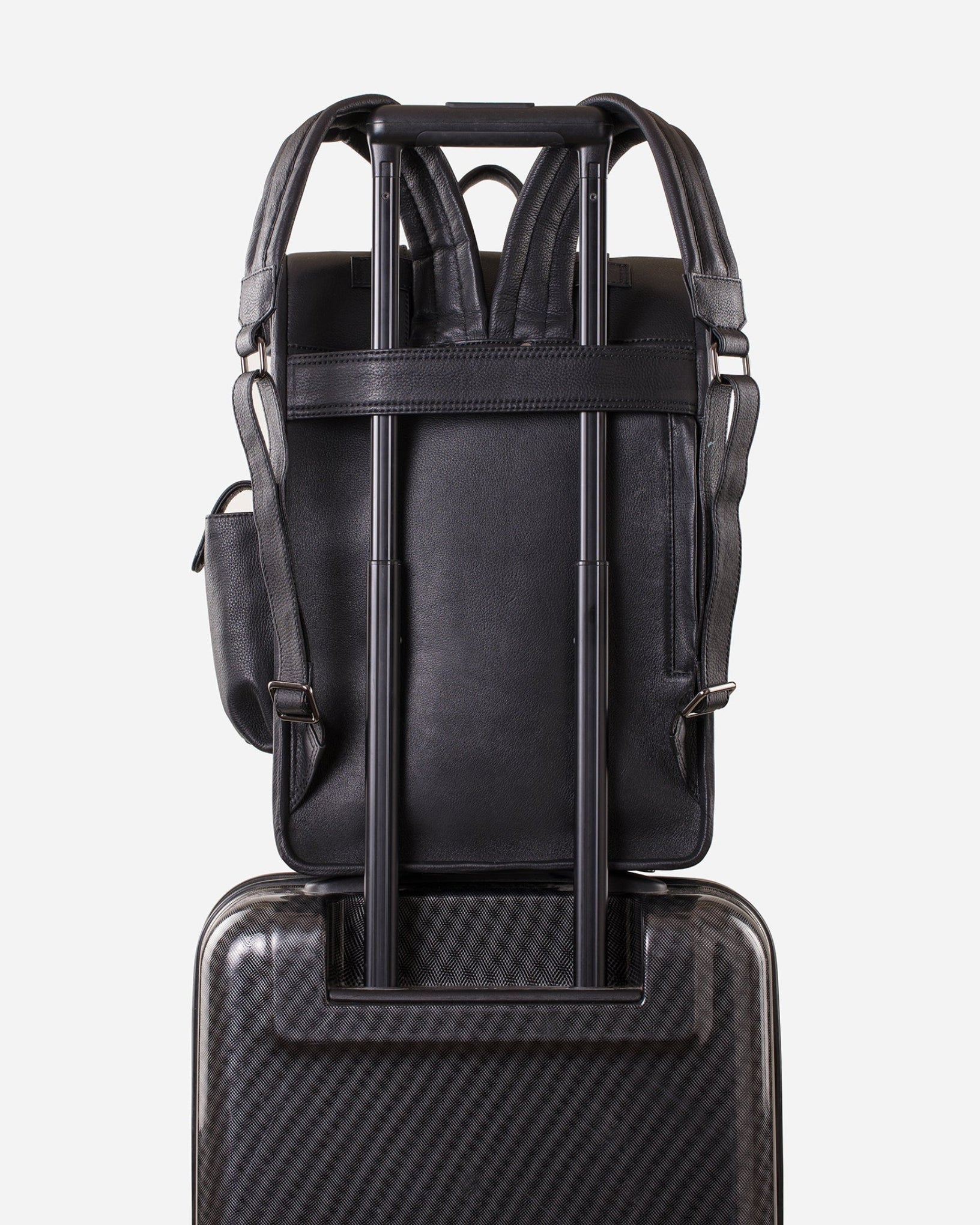 Carbon Black: back view showing trolley sleeve usage of Garrten rolltop style full grain leather backpack