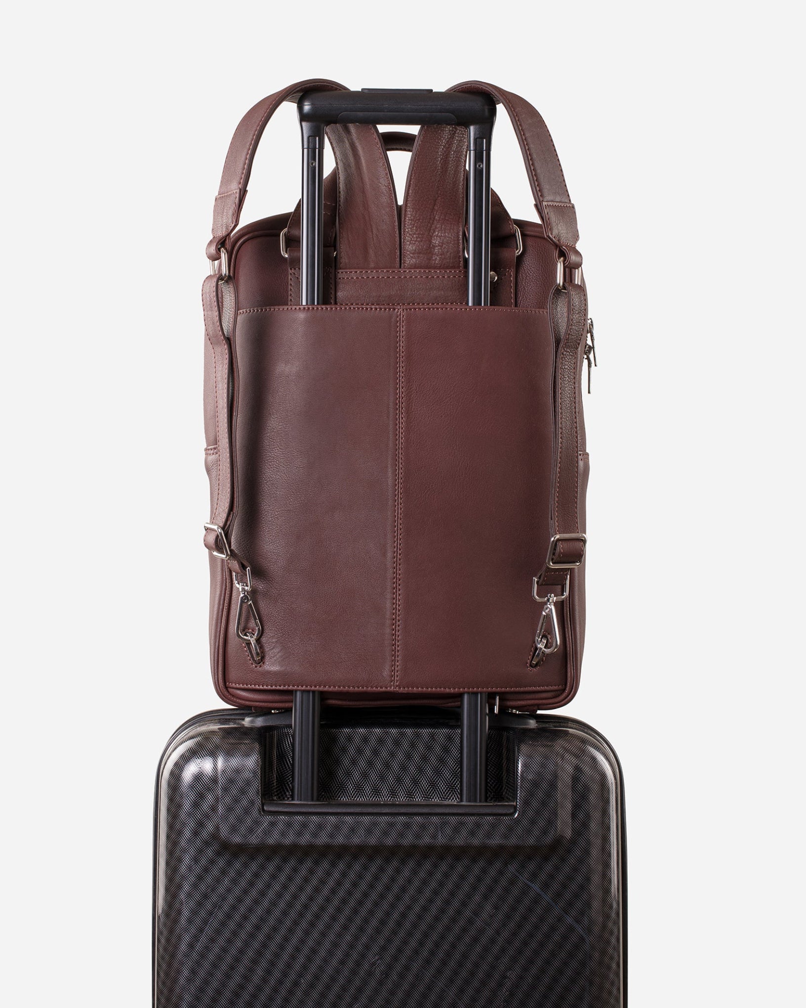 Mahogany Brown: back view showing trolley sleeve usage of Garrten signature convertible full grain leather backpack