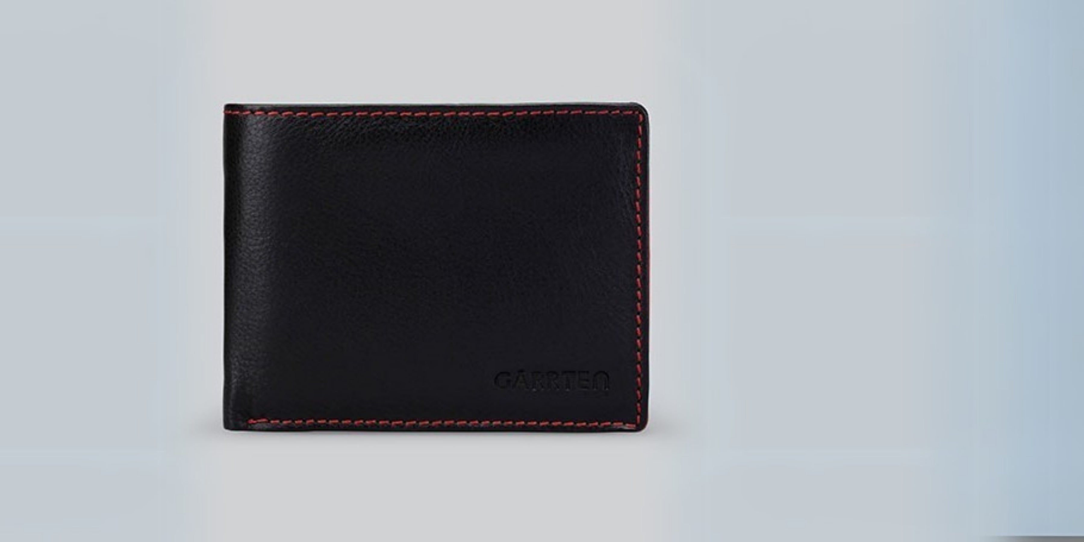 GARRTEN Black leather wallet with red  stitching on a light gray background