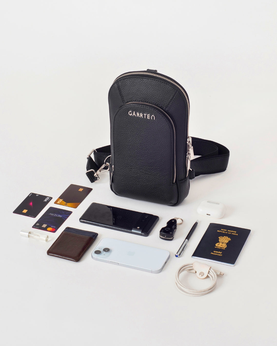 GARRTEN 518 italian leather crossbody sling bag in carbon black — flatlay showing the capacity