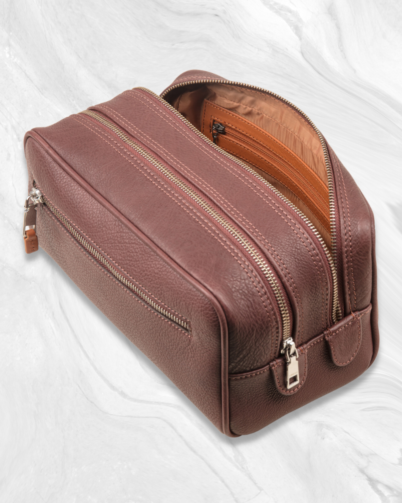 Garrten Brown leather toiletry bag with ykk zipper on a white background