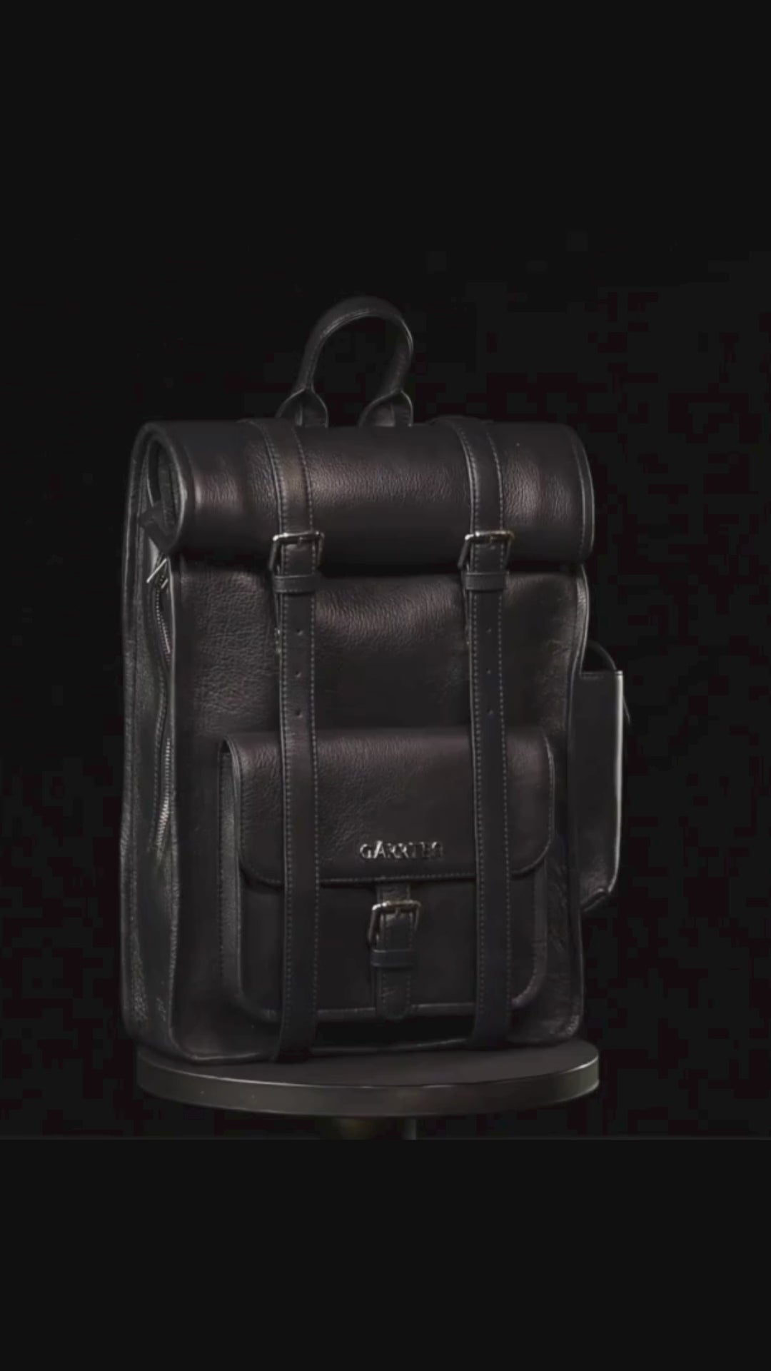 GARRTEN 751 ROLLTOP  leather backpack in midnight blue on a turn table— product video in vertical format showing bag 360 degree on a black background