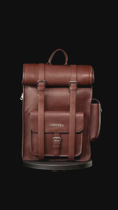 GARRTEN 751 rolltop leather backpack in vintage mahogany brown on a turn table— product video in vertical format showing bag 360degree on a black background