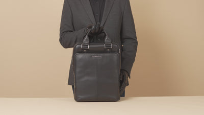 GARRTEN 821 signature italian leather backpack in carbon black — product video thumbnail showing backpack features on a beige background
