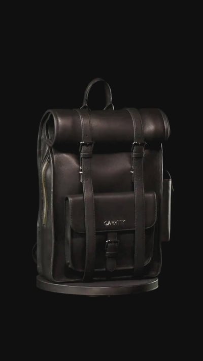 GARRTEN 751 iconic rolltop  leather backpack in carbon black on a turn table— product video in vertical format showing bag 360 degree on a black background