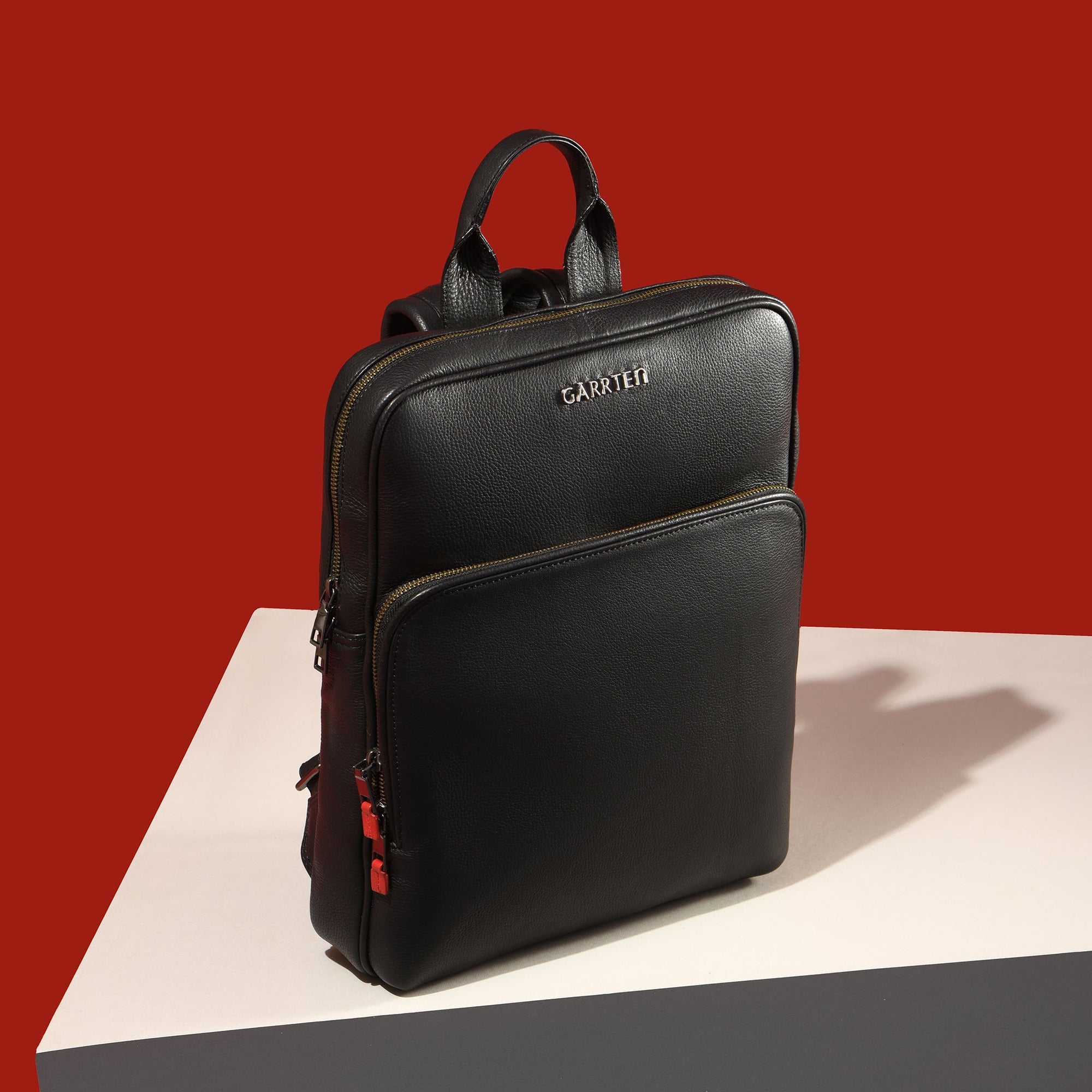 Carbon Black: tilt view of Garrten slim full grain leather backpack-moodshot