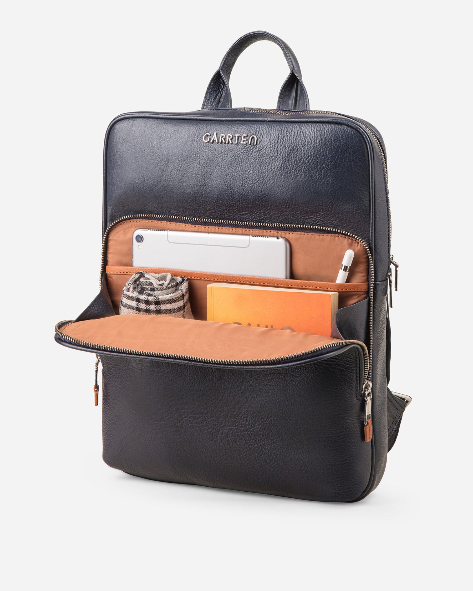GARRTEN 731 slim full-grain leather backpack in midnight blue — front zipper pocket open showing cinnamon interior with card slots, pen loops, cable loops and tablet or document pocket