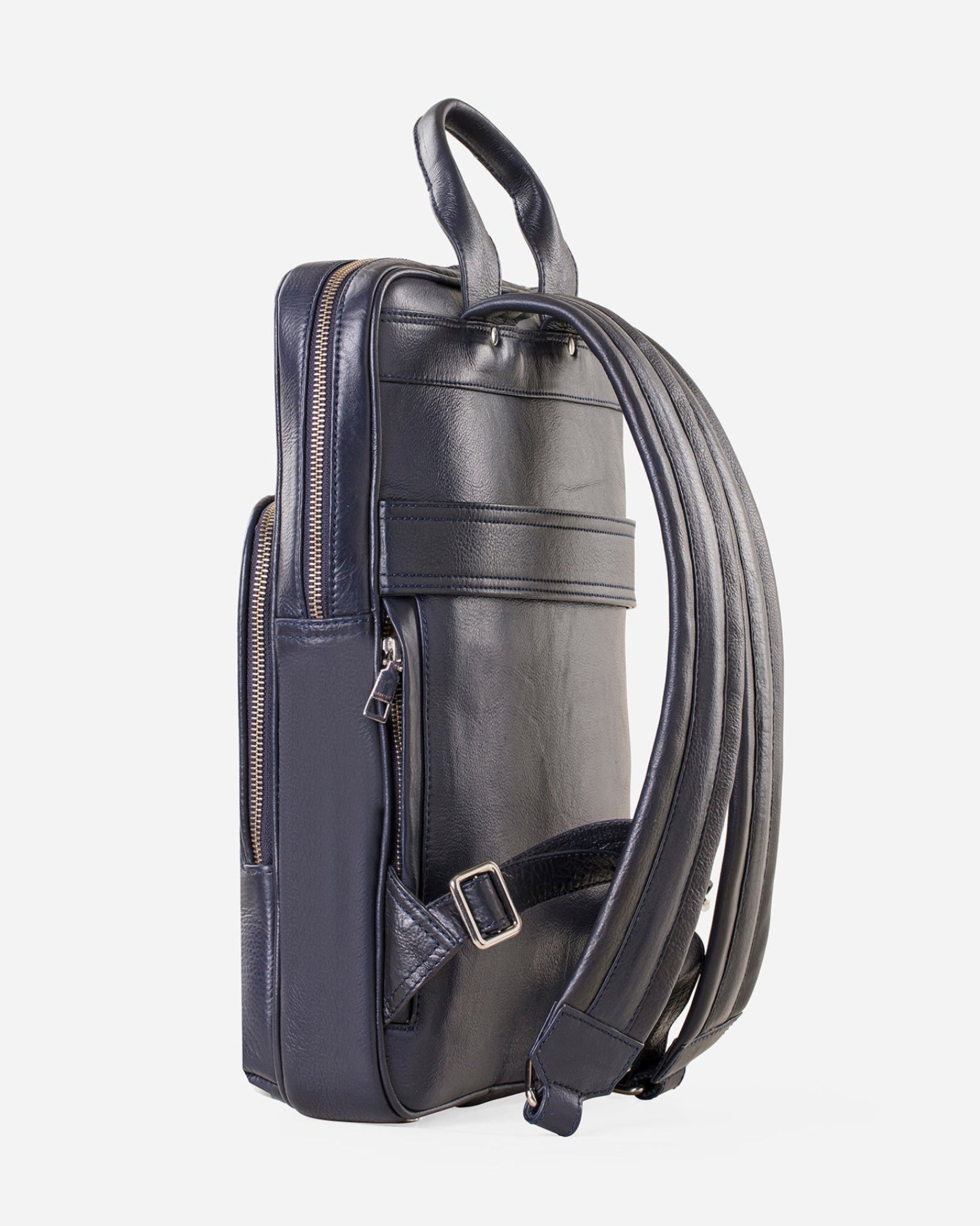 GARRTEN 731 slim full-grain leather backpack in midnight blue — side view emphasising ultra-slim 5cm depth profile with adjustable padded leather shoulder straps, white background