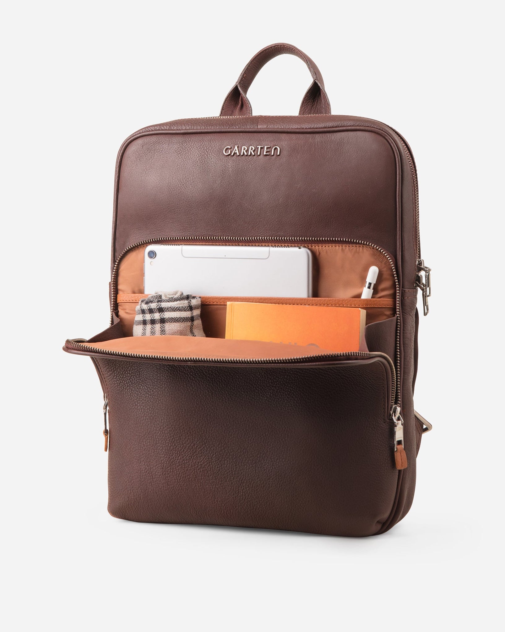 GARRTEN 731 slim full-grain leather backpack in vintage mahogany brown — front zipper pocket open showing cinnamon interior with card slots, pen loops, cable loops and tablet or document pocket
