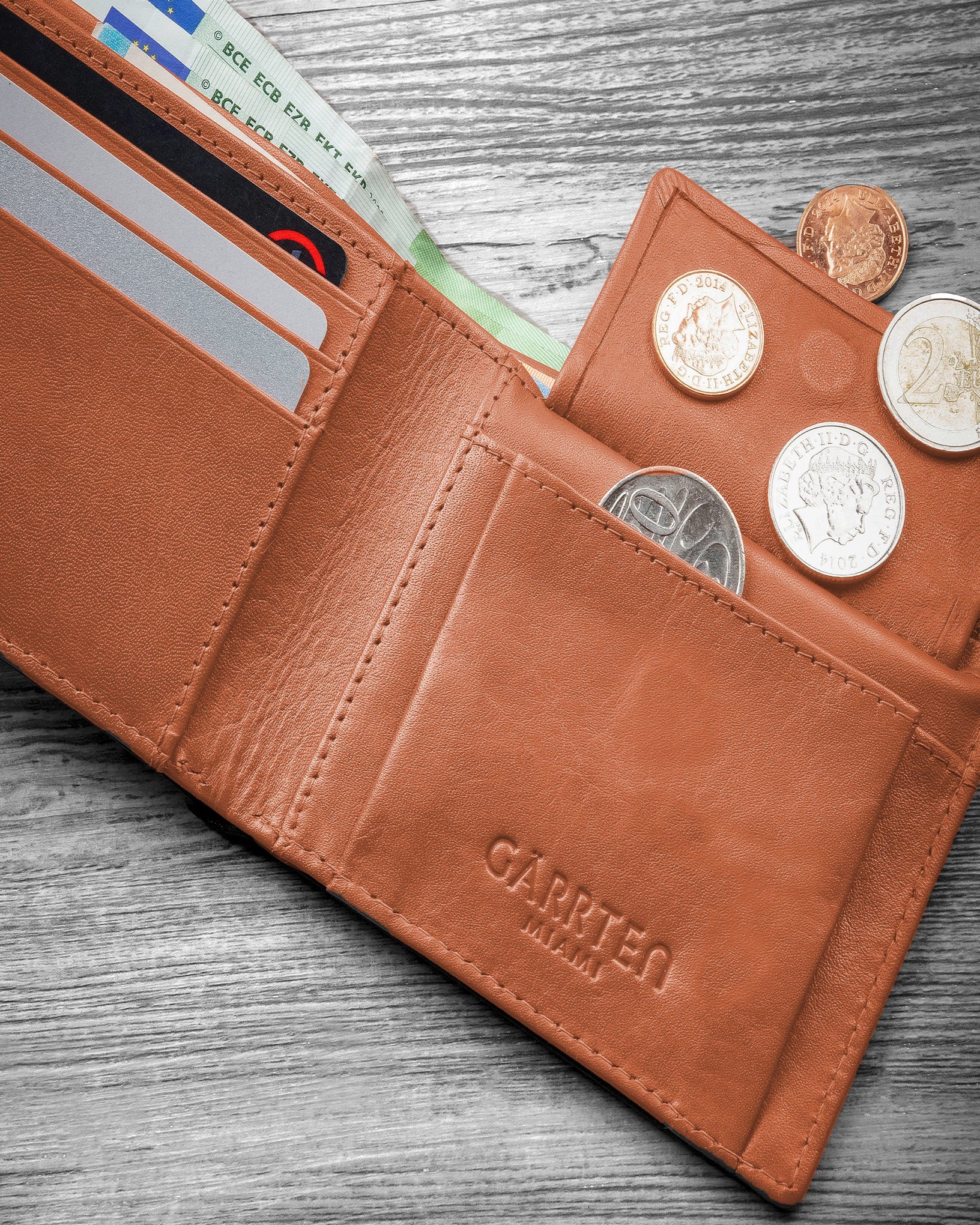 GARRTEN 219 slim full grain leather wallet grey/tan — open billfold on wooden surface showing tan interior and card organisation